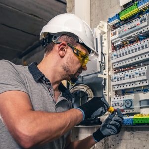 man-electrical-technician-working-switchboard-with-fuses